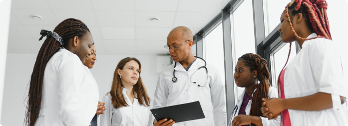 A medical professional is taking notes during a patient visit